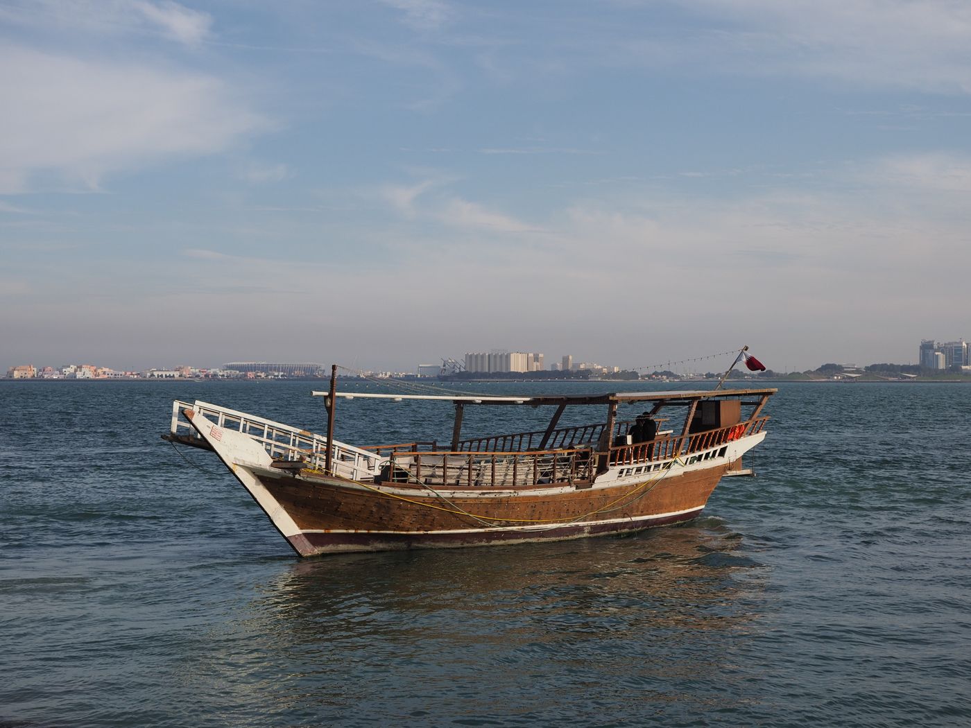 un barco tradicional de madera navegando cerca de la costa